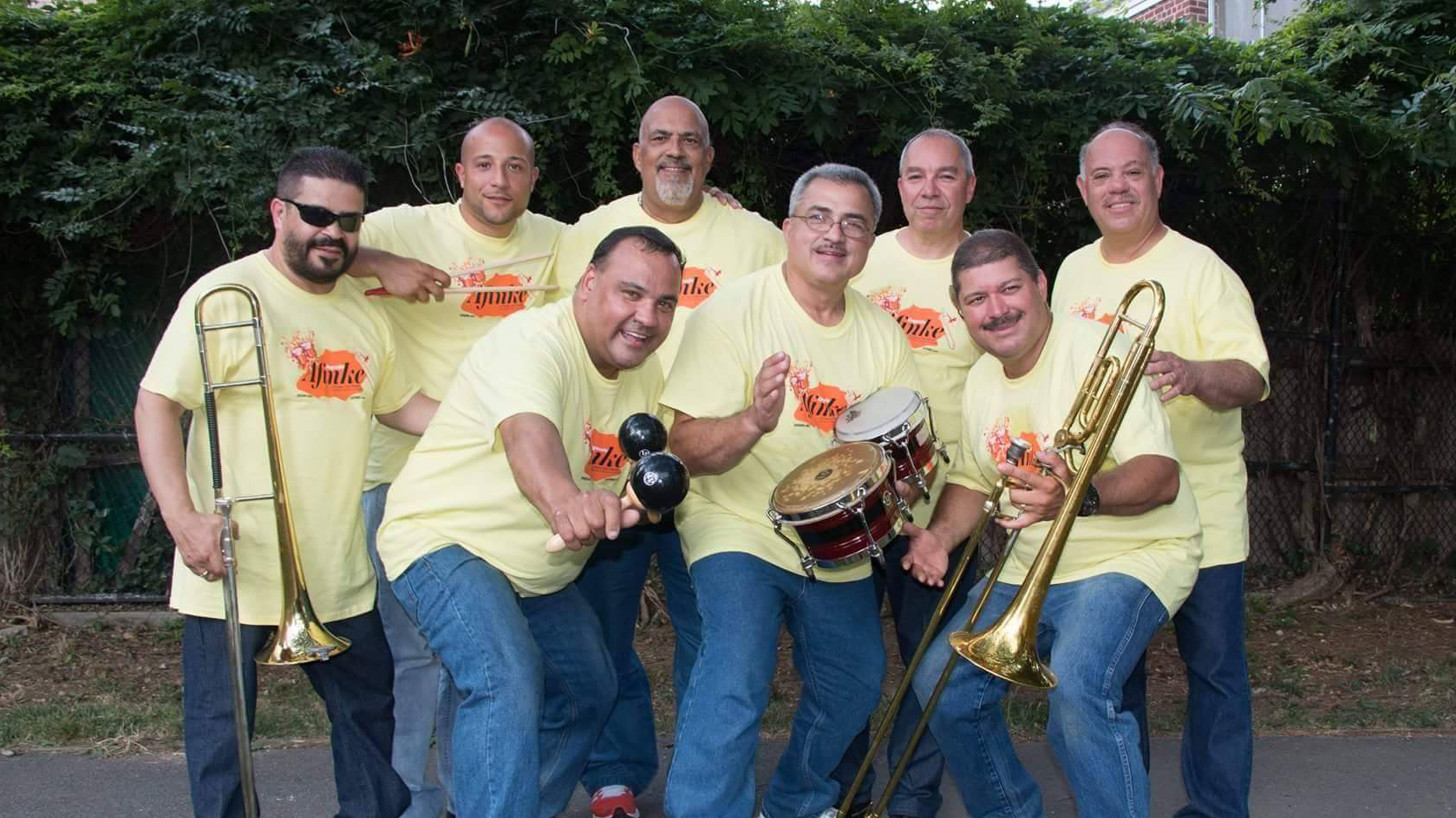 band members of Orquesta Afinke posed with their instruments and smiling